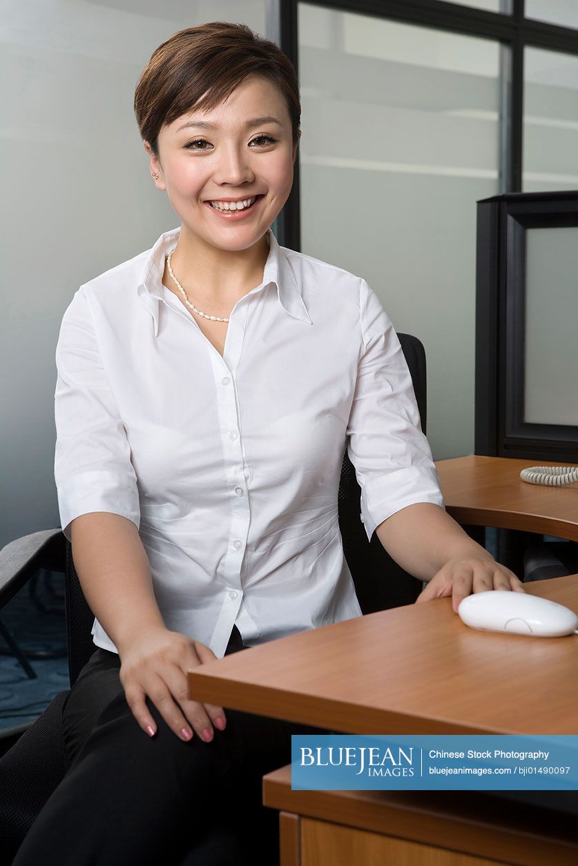 Chinese office worker at her desk