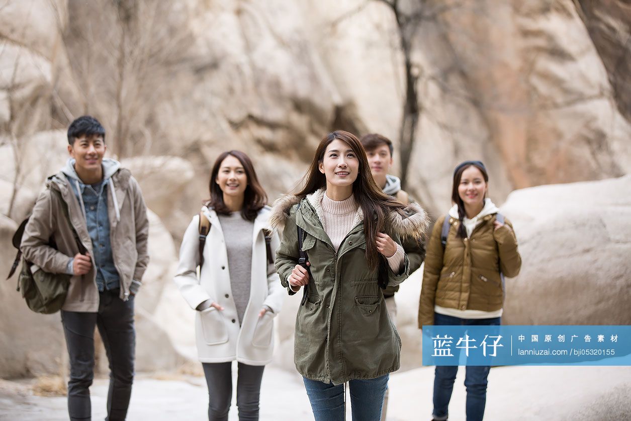 Happy young Chinese friends enjoying winter outing