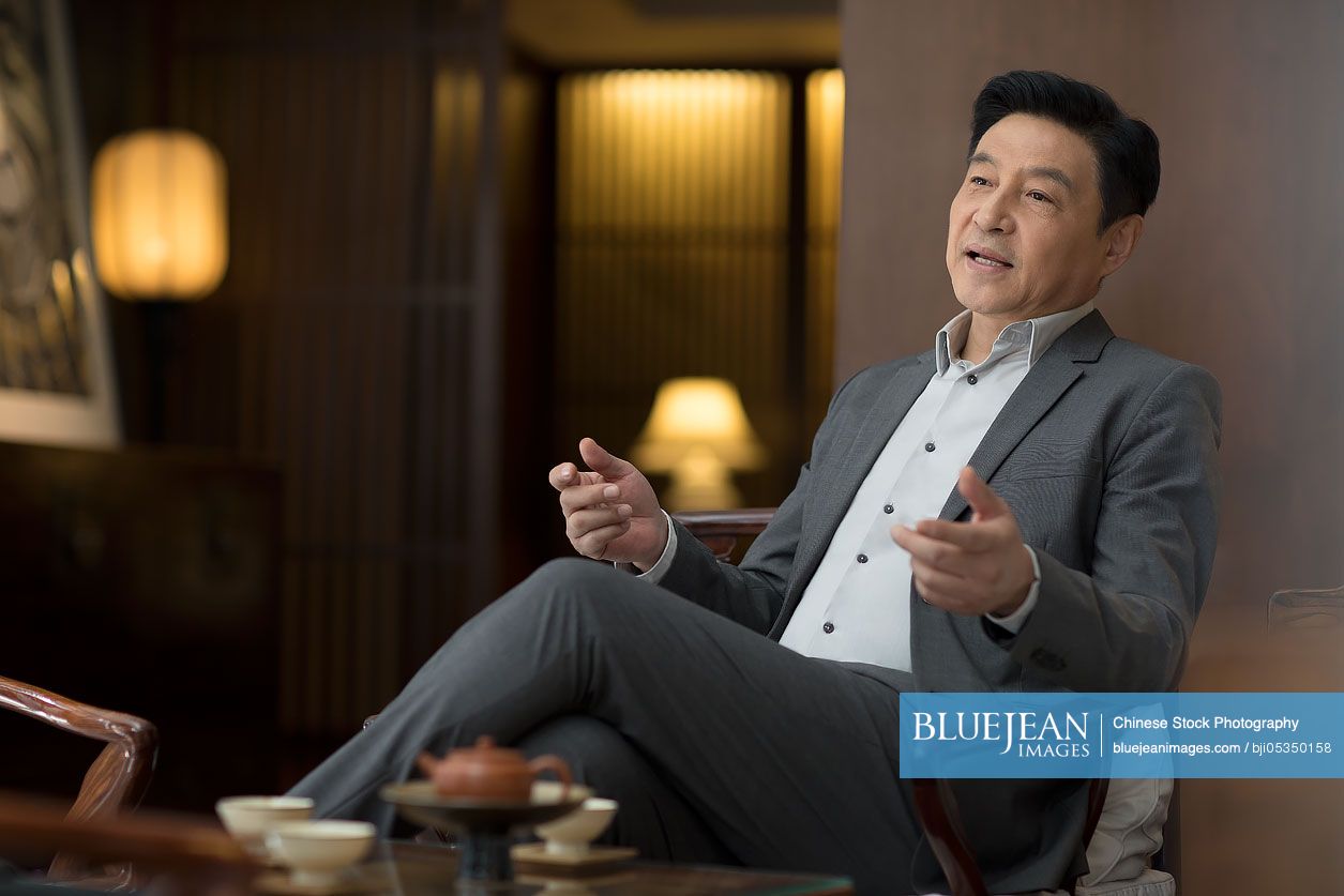 Cheerful Chinese businessman talking