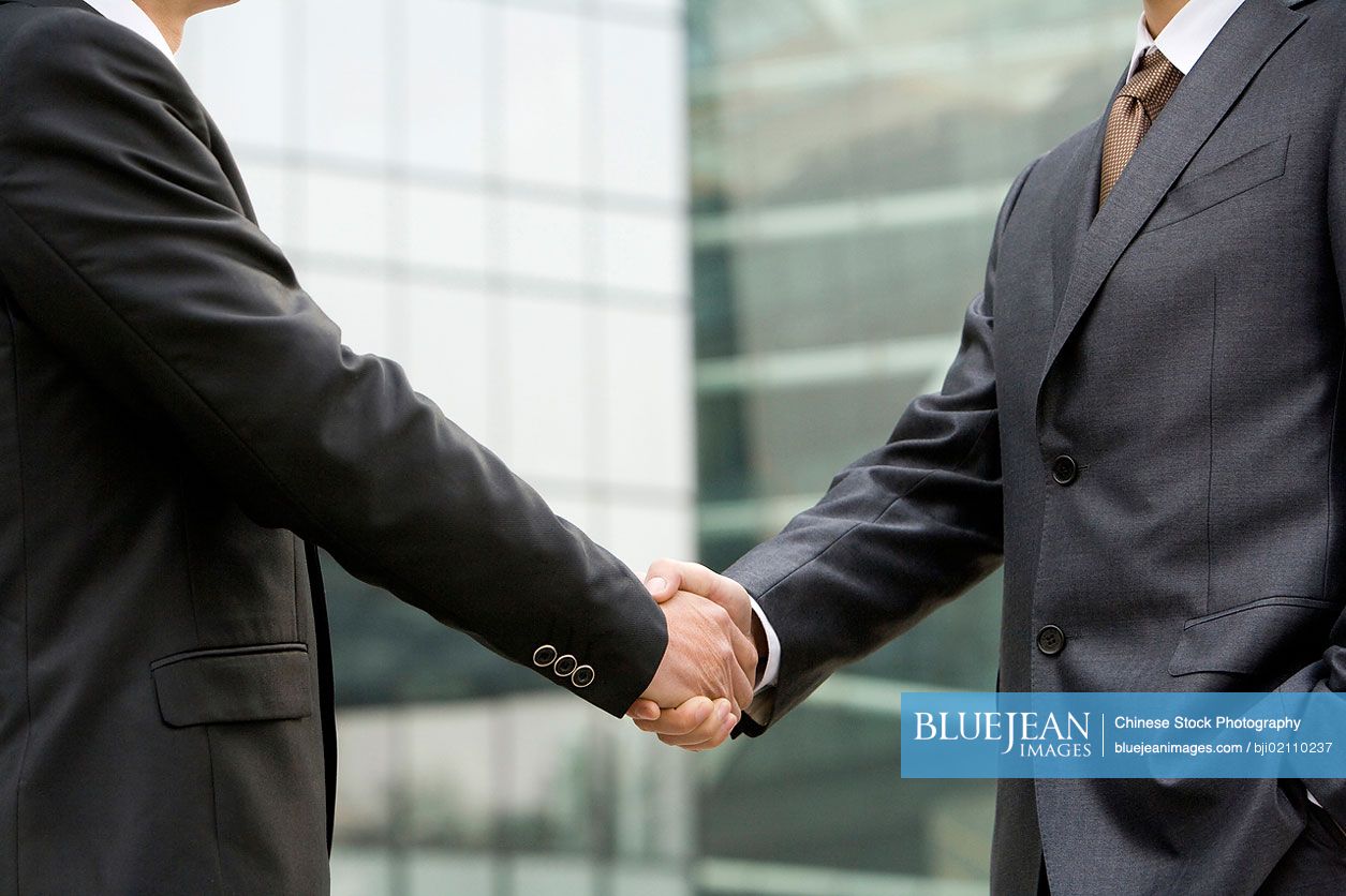 Chinese businessmen shaking hands