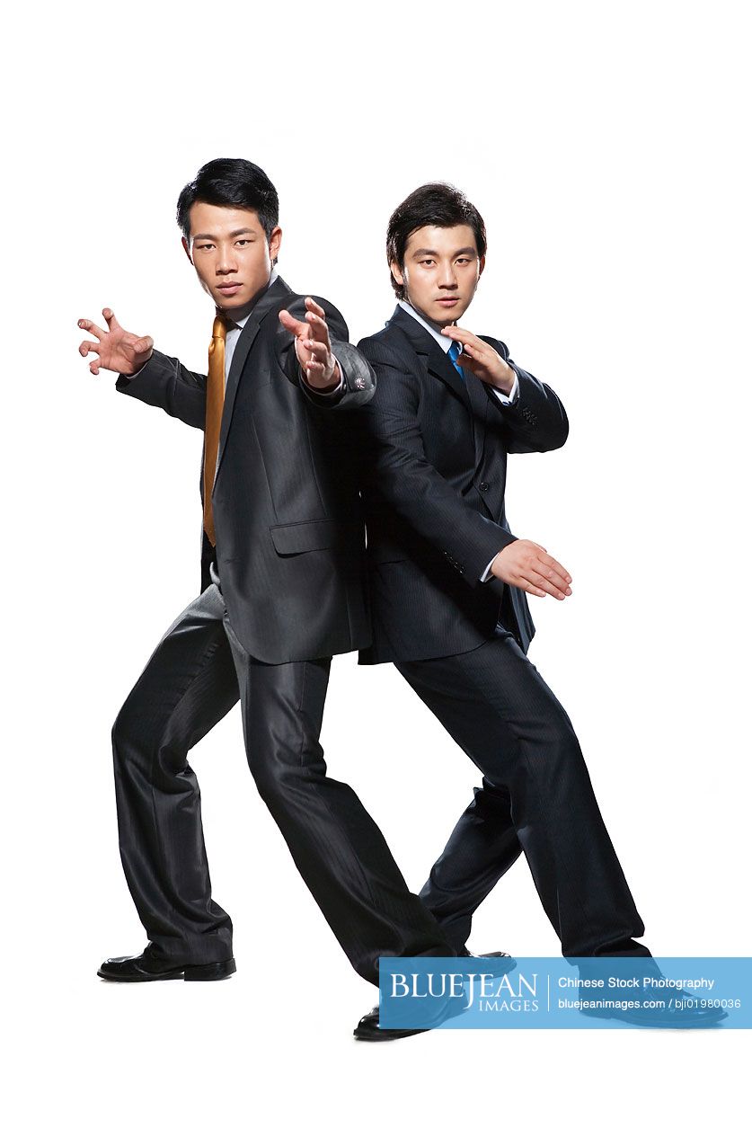 Two Chinese businessmen in fighting stance