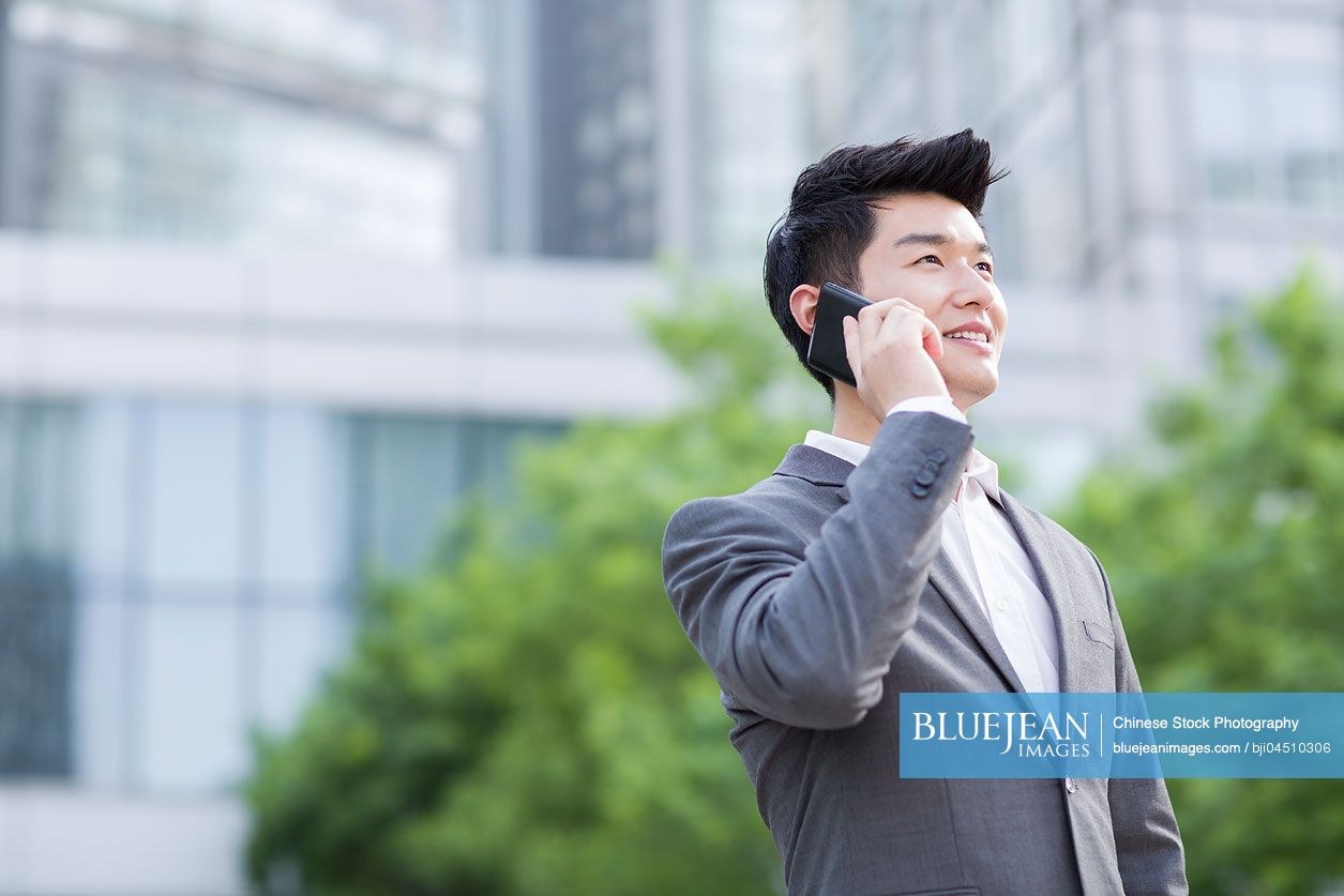 Young Chinese businessman talking on the phone