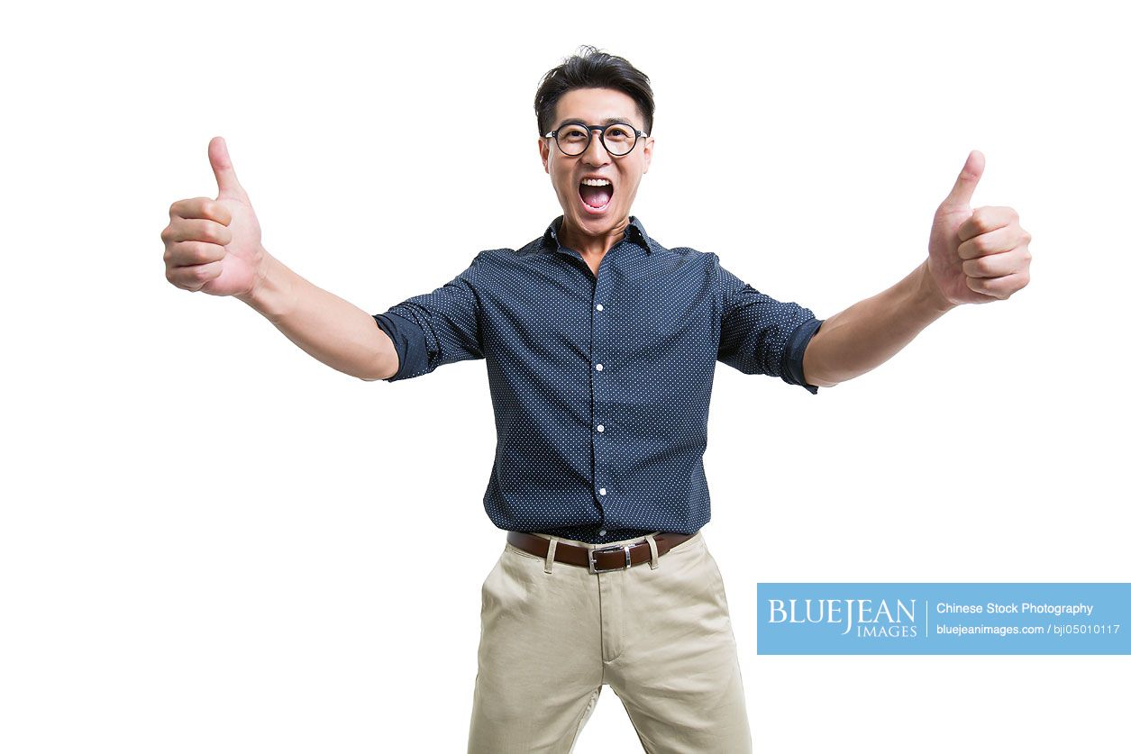 Happy young Chinese man doing thumbs up
