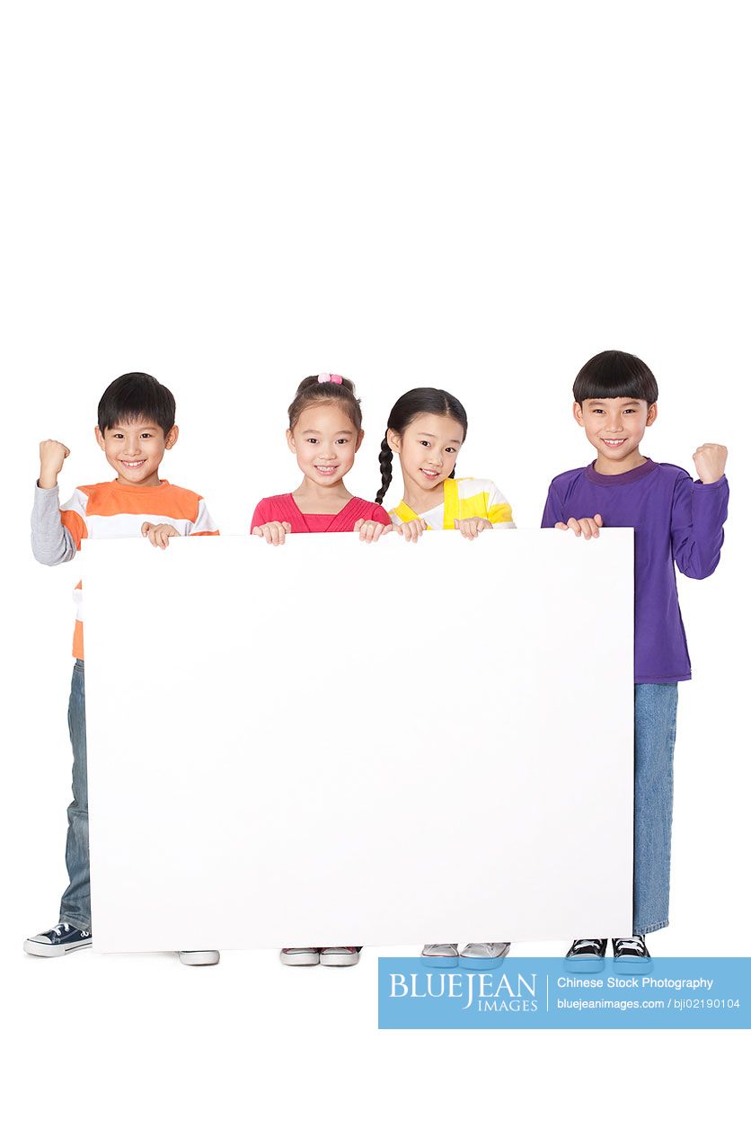 A group of Chinese classmates holding up a blank sign
