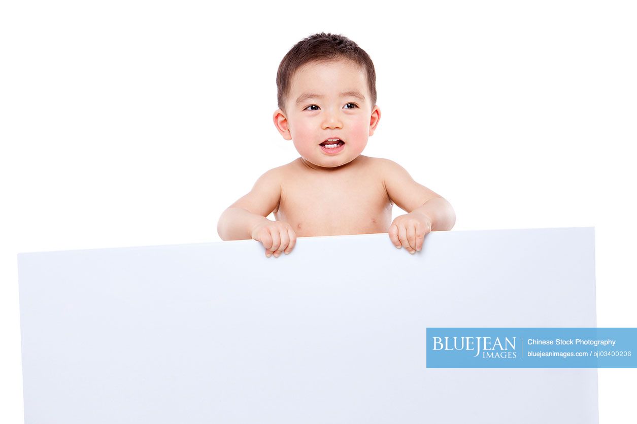 Cute Chinese baby boy with white board