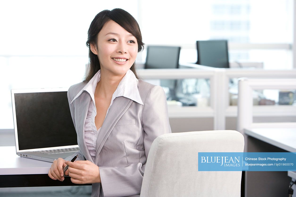 Chinese office worker at her desk