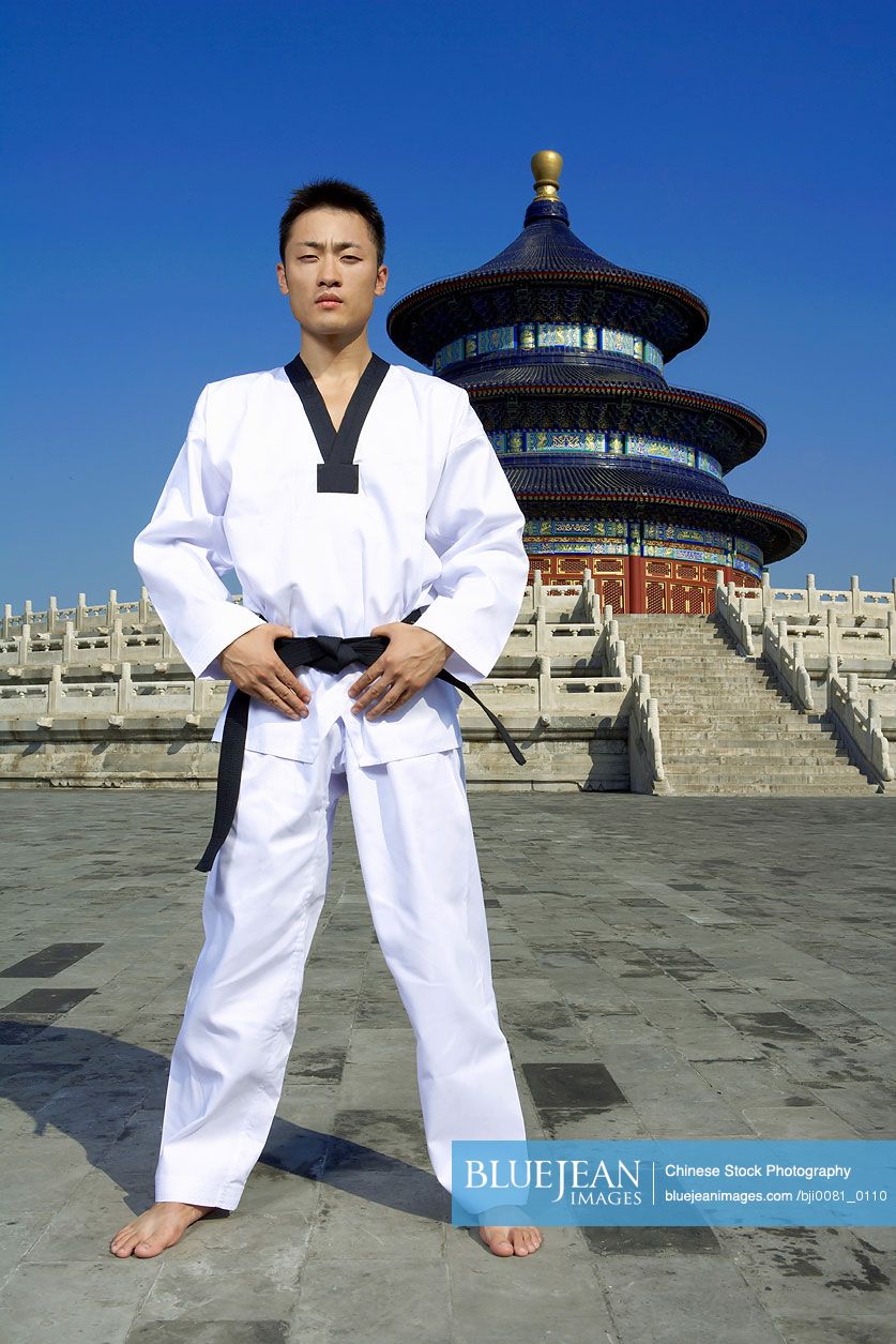 Portrait Of Young Male Chinese Martial Artist In Front Of Temple