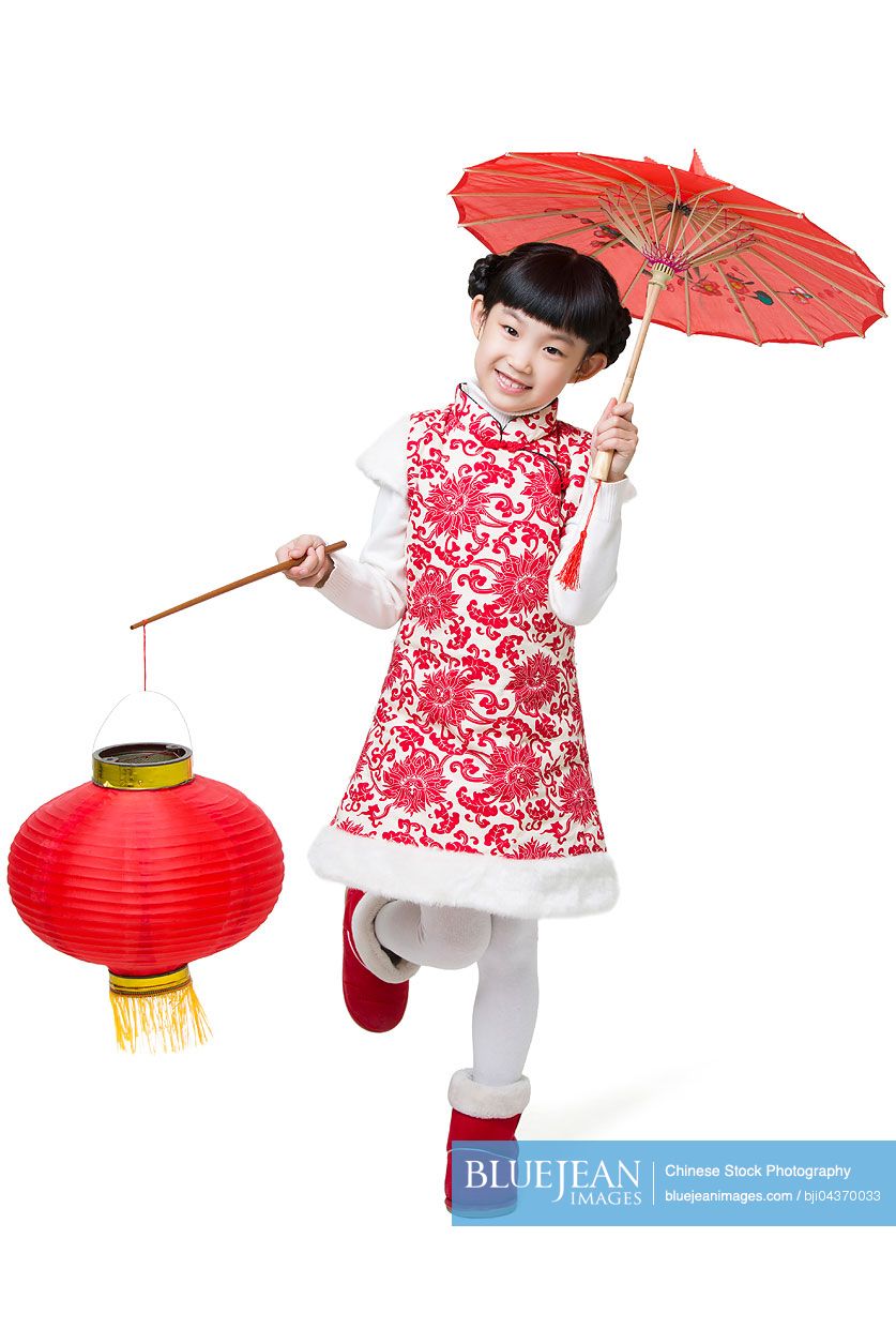Happy girl holding paper umbrella and Chinese lantern