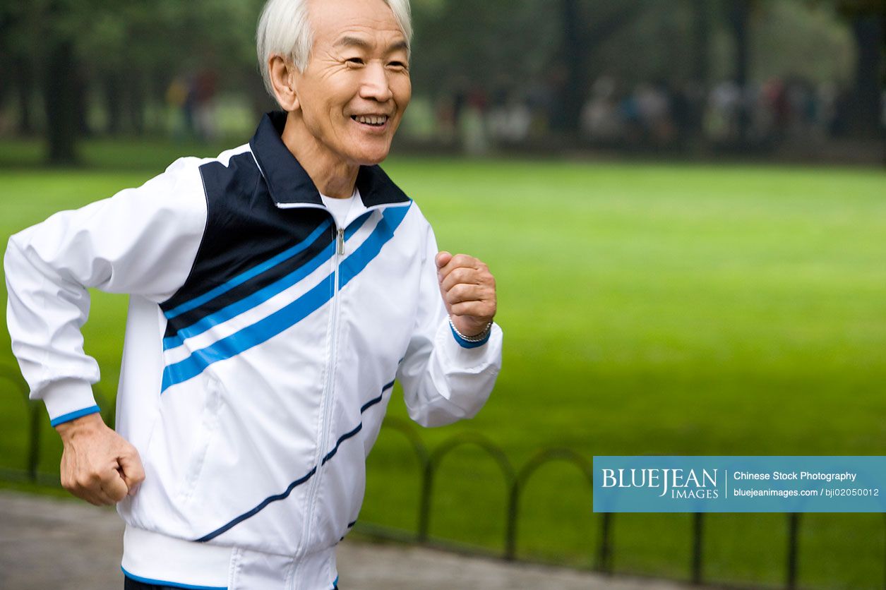 Senior Chinese man running in a park