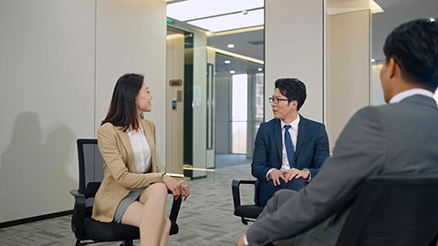 Chinese business people having meeting in empty office