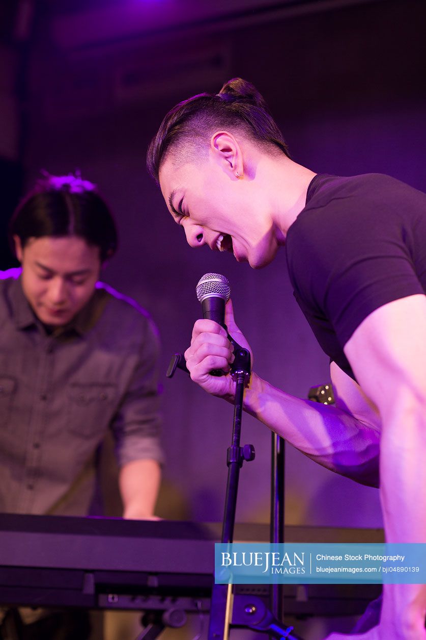 Young Chinese man singing on stage