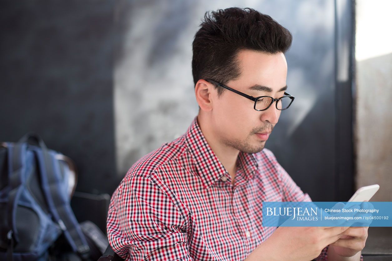 Chinese man using smart phone