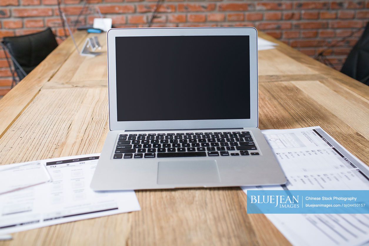 A laptop on conference table
