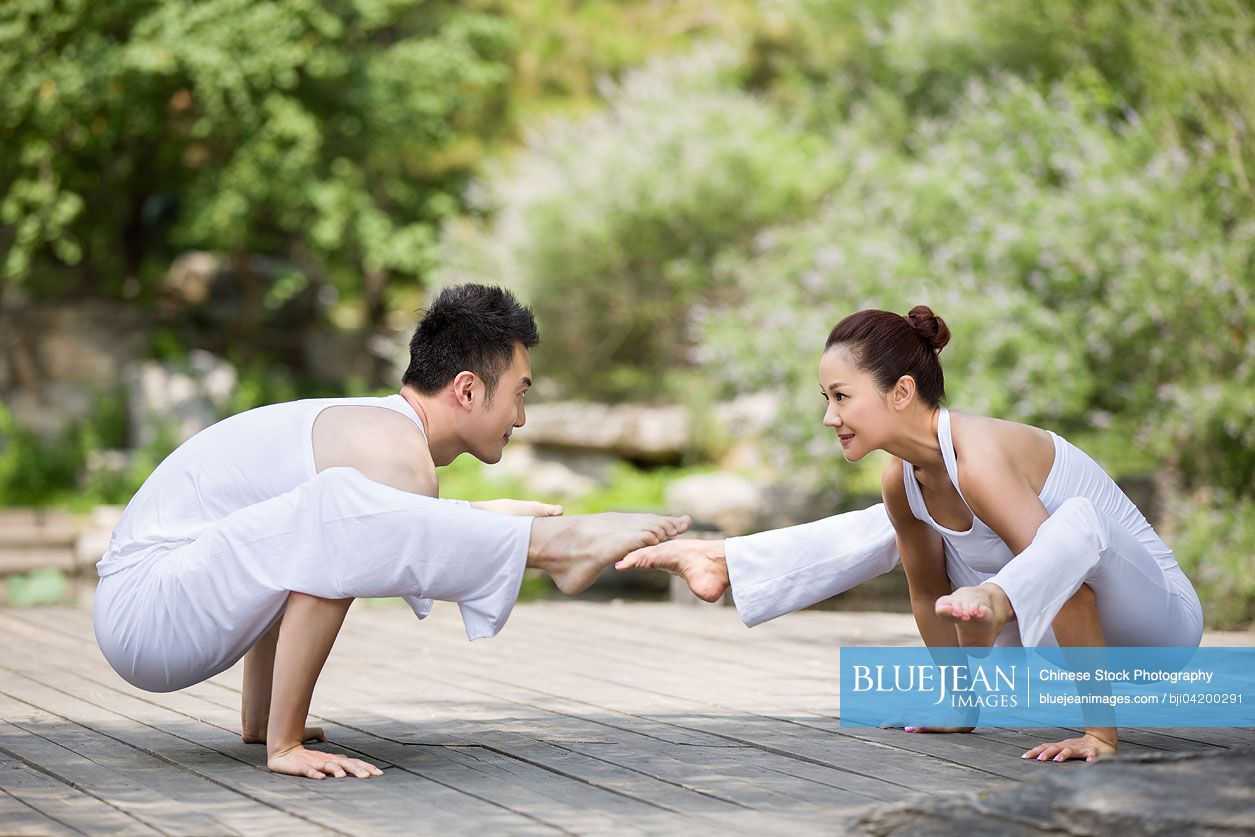 Young Chinese couple doing yoga