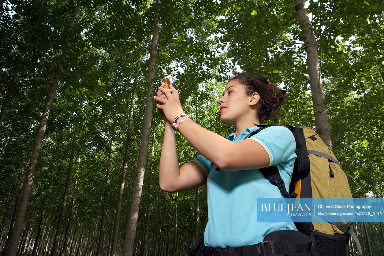 Chinese Woman Holding GPS System Up