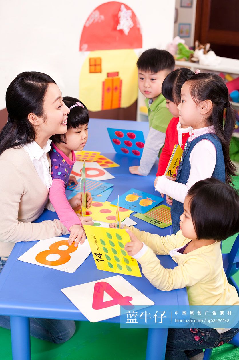 幼儿园老师教孩子们辨认卡片