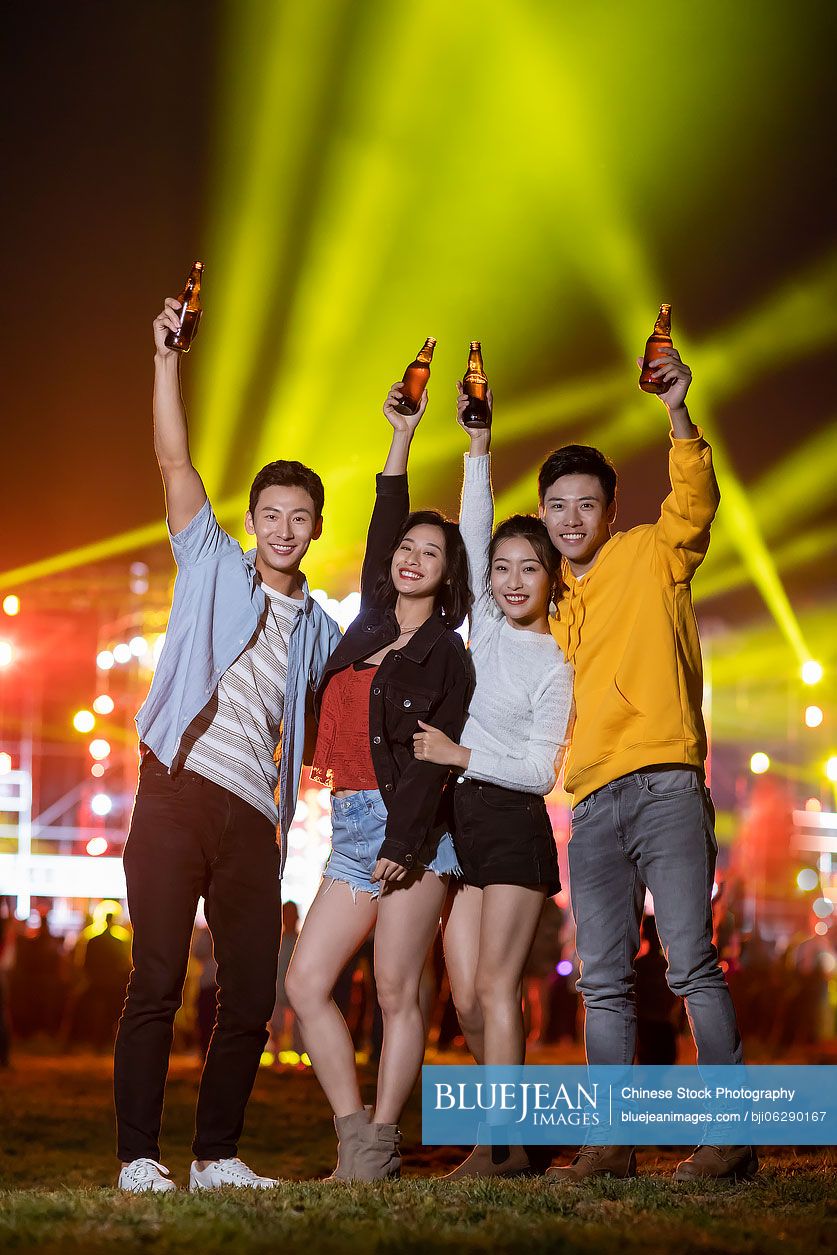 Happy young Chinese friends at music festival
