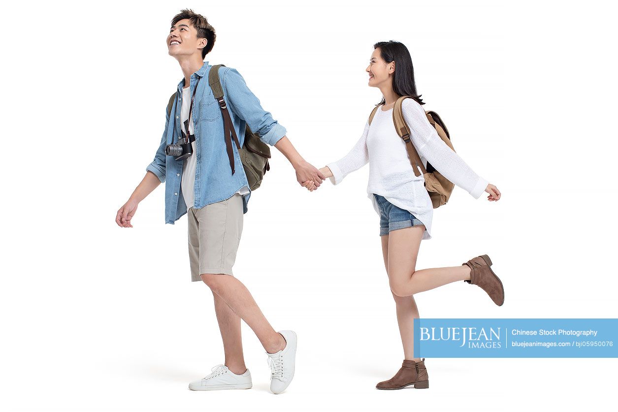 Happy young Chinese couple travelling together