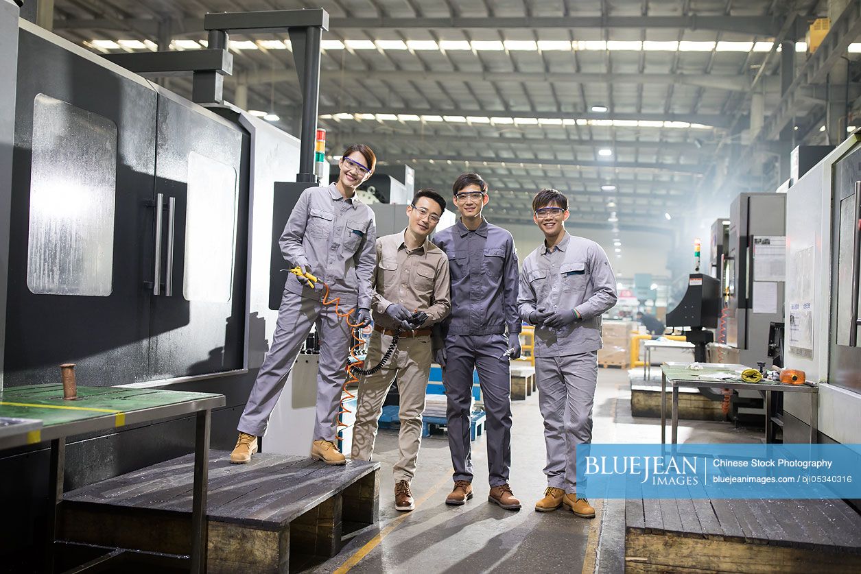 Confident Chinese engineers in the factory