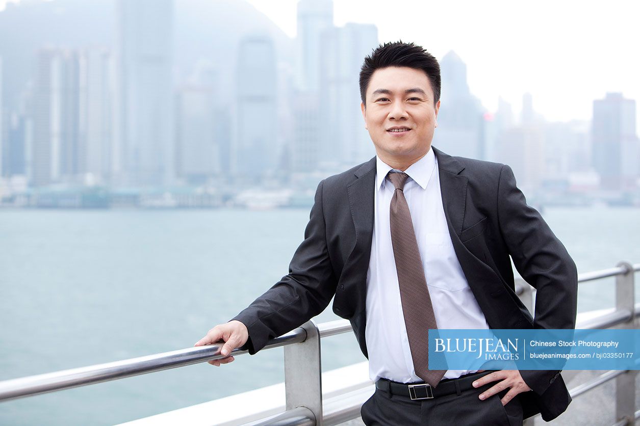 Adroit Chinese businessman hand on hip, Hong Kong
