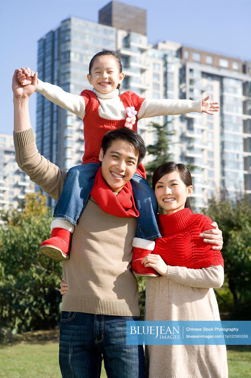 Young Chinese family enjoying a park in autumn