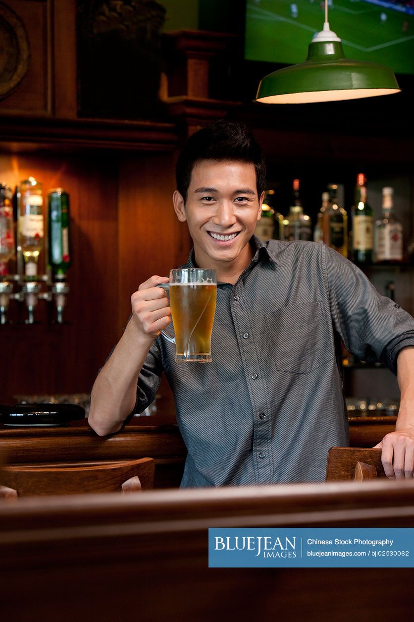 A Chinese man relaxing at a bar