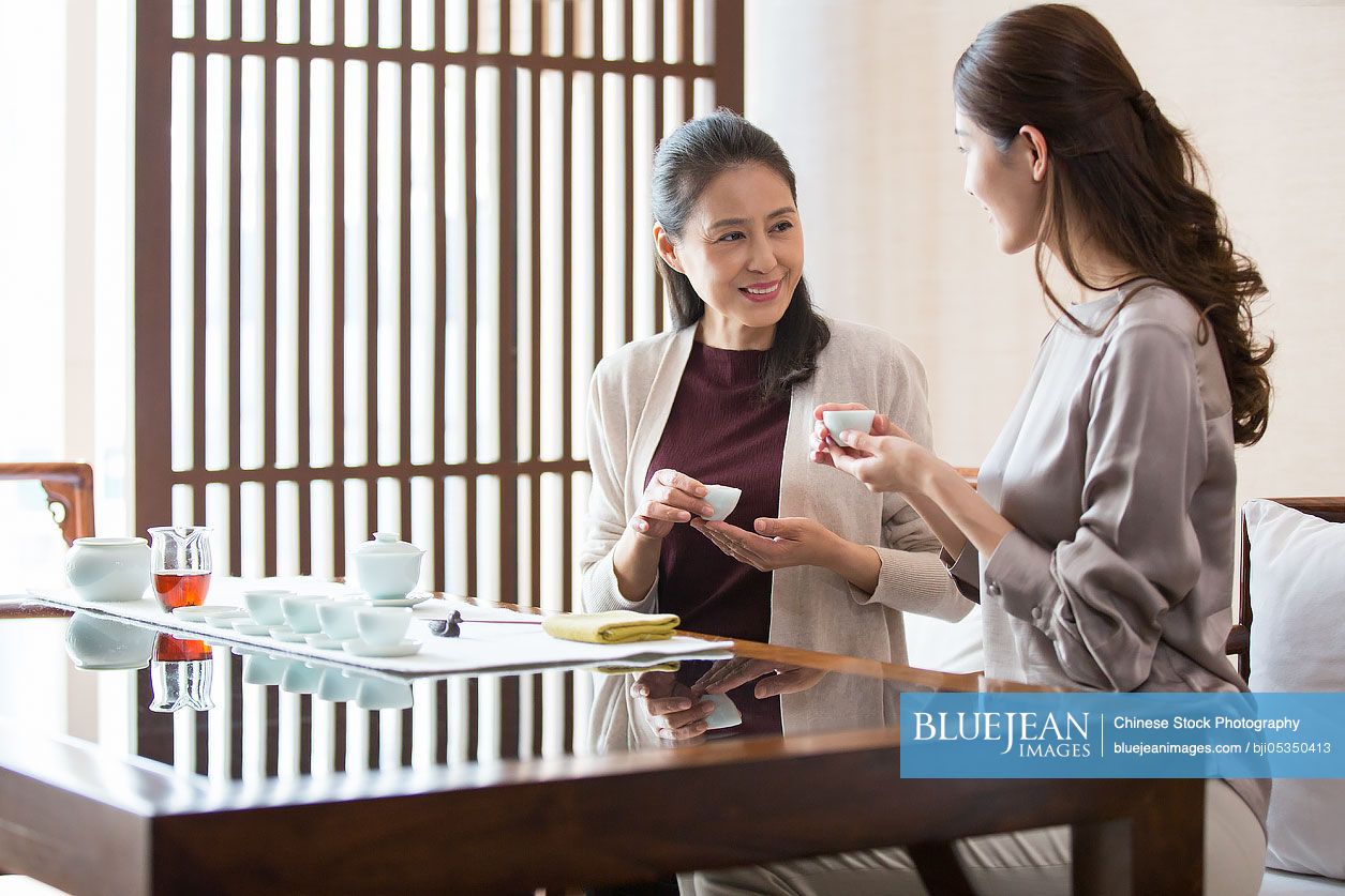 Elegant Chinese women drinking tea