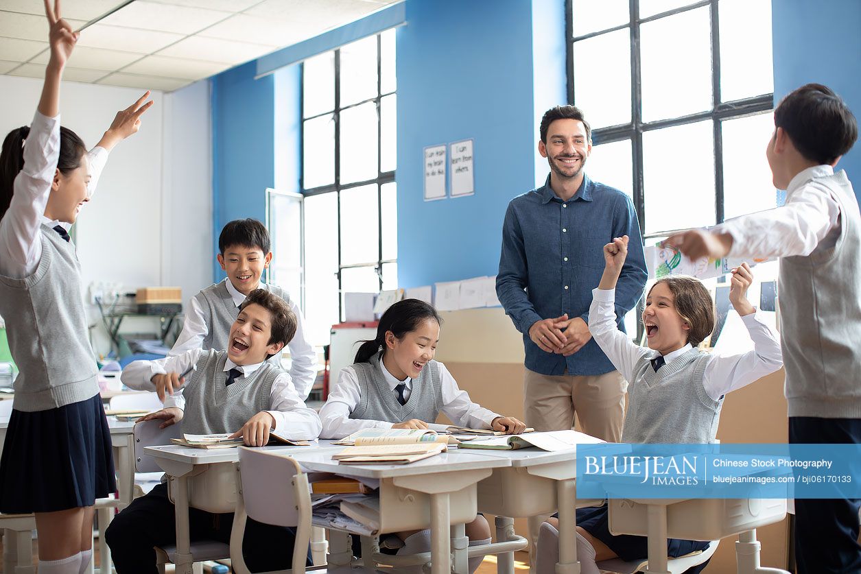 Students and teacher celebrating in classroom