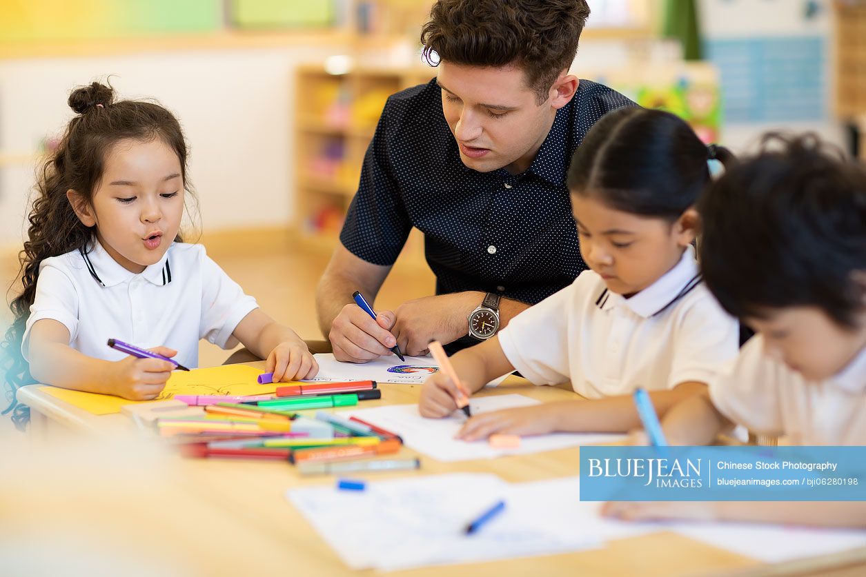 Foreign teacher teaching art class in classroom