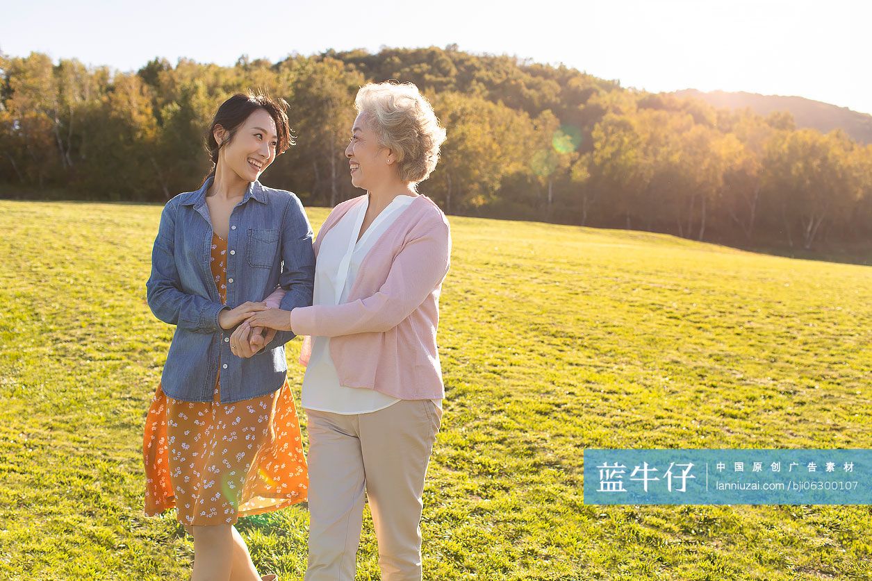 快乐的母女俩在草地上散步