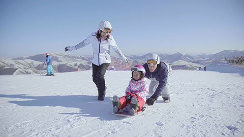 Happy young Chinese family relaxing in ski resort,4K