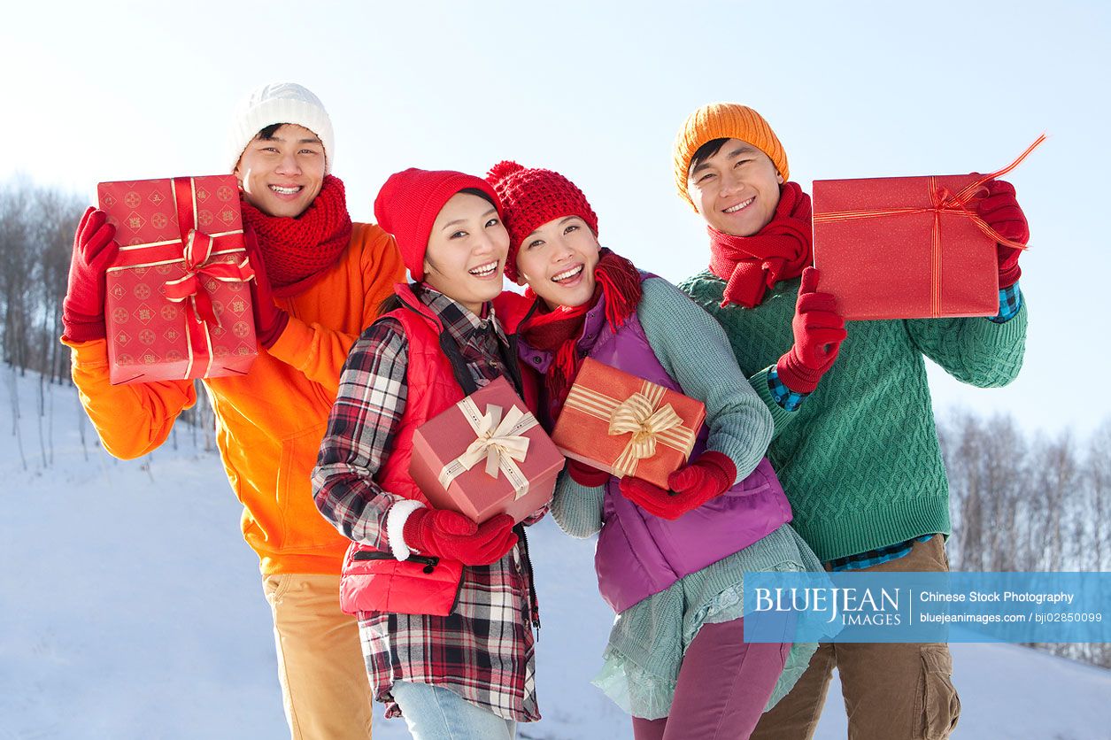 Young Chinese holding gift boxes