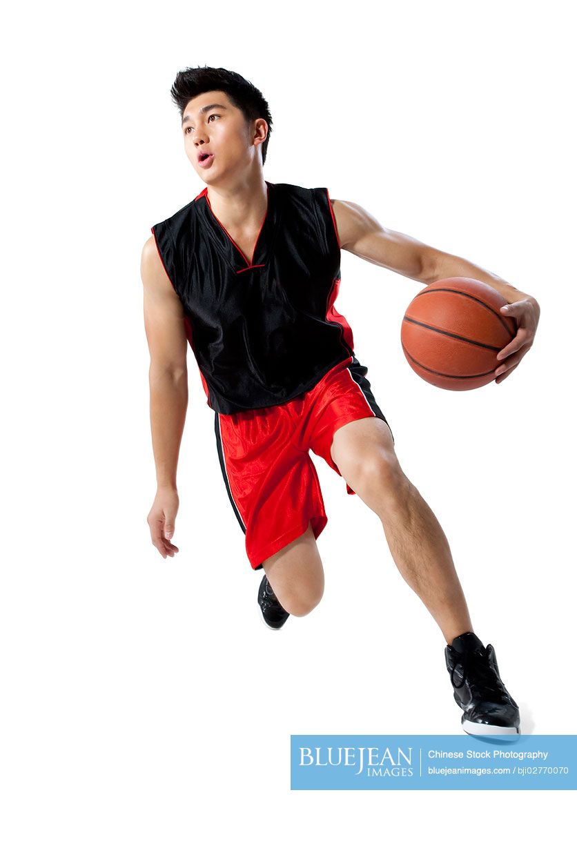Chinese man dribbling basketball
