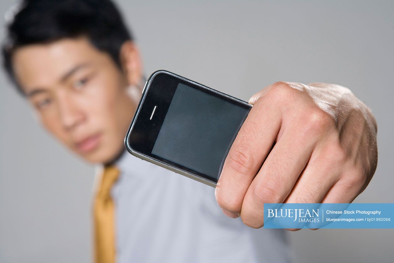 Chinese businessman holding iPhone
