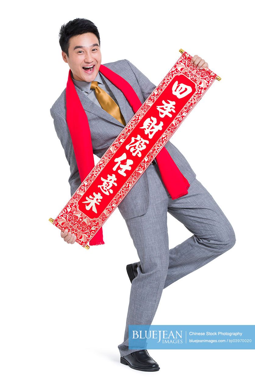 Cheerful Chinese businessman with couplet