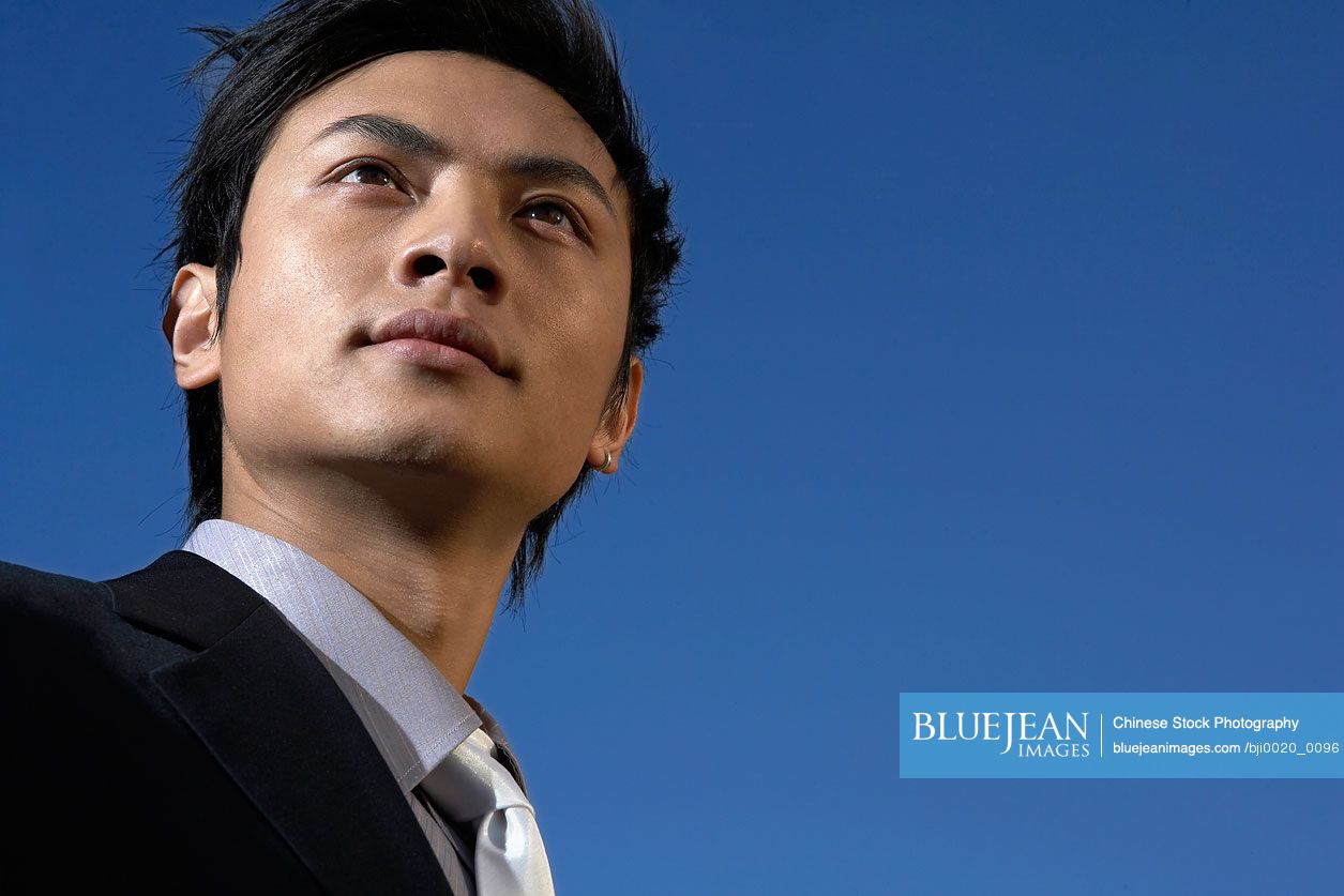 young-chinese-businessman-staring-confidently-into-the-distance-high