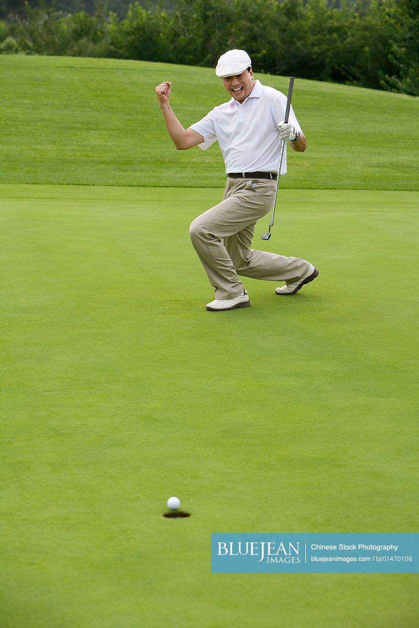 Chinese golfer celebrating a nice putt