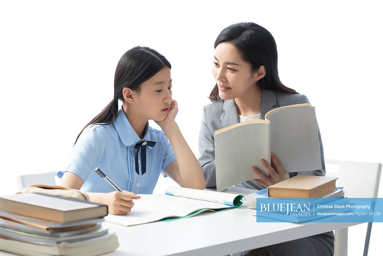 Chinese teacher helping girl with homework