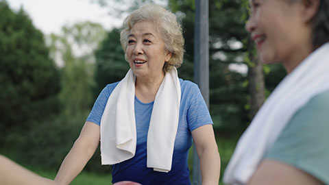 Happy senior Chinese friends exercising in park,4K