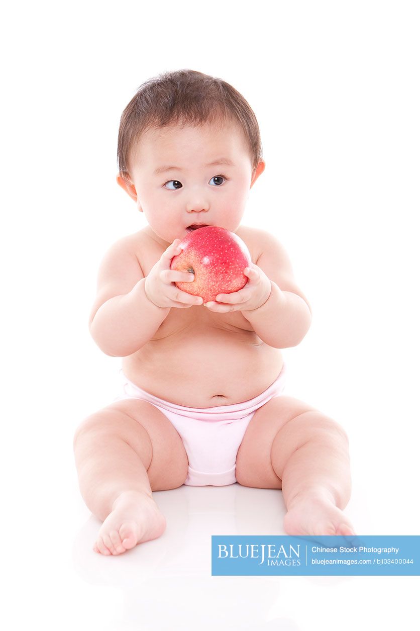 Cute Chinese baby girl and apple-High-res stock photo for download