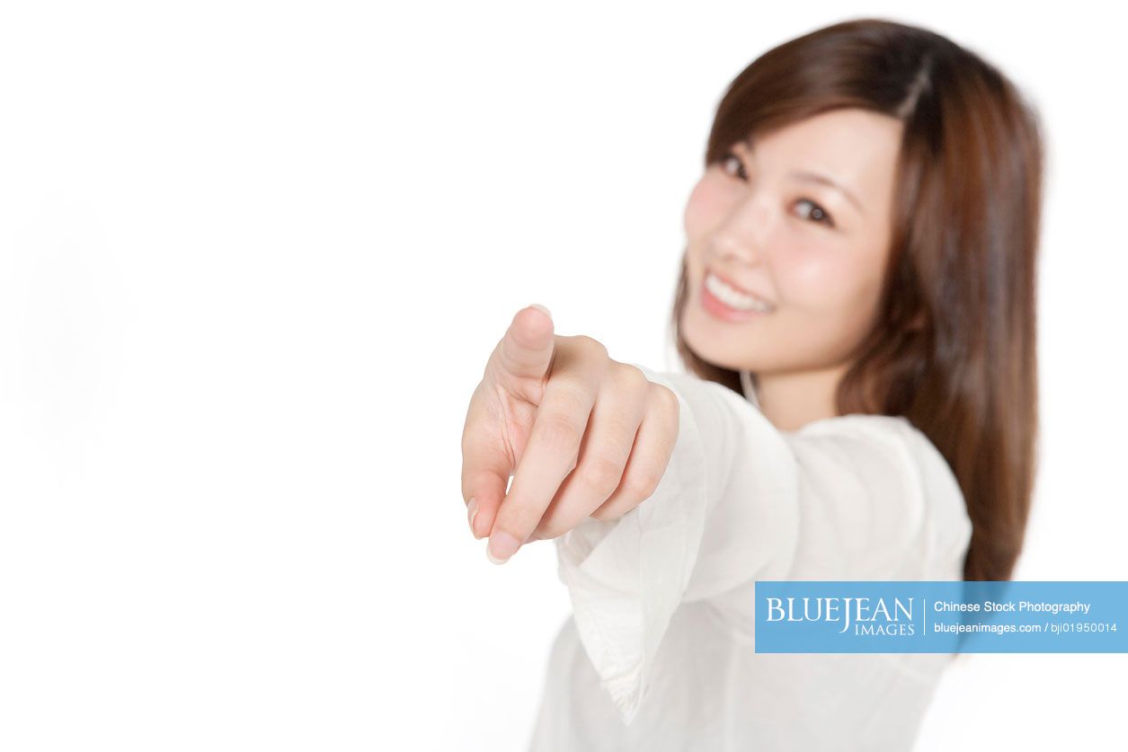 Portrait of young Chinese woman pointing