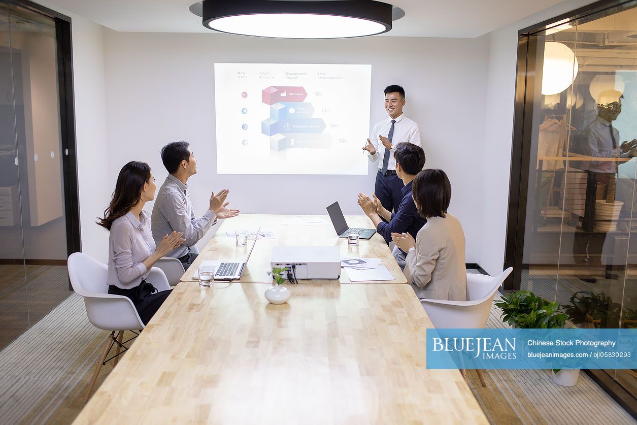 Chinese business people having meeting in board room 