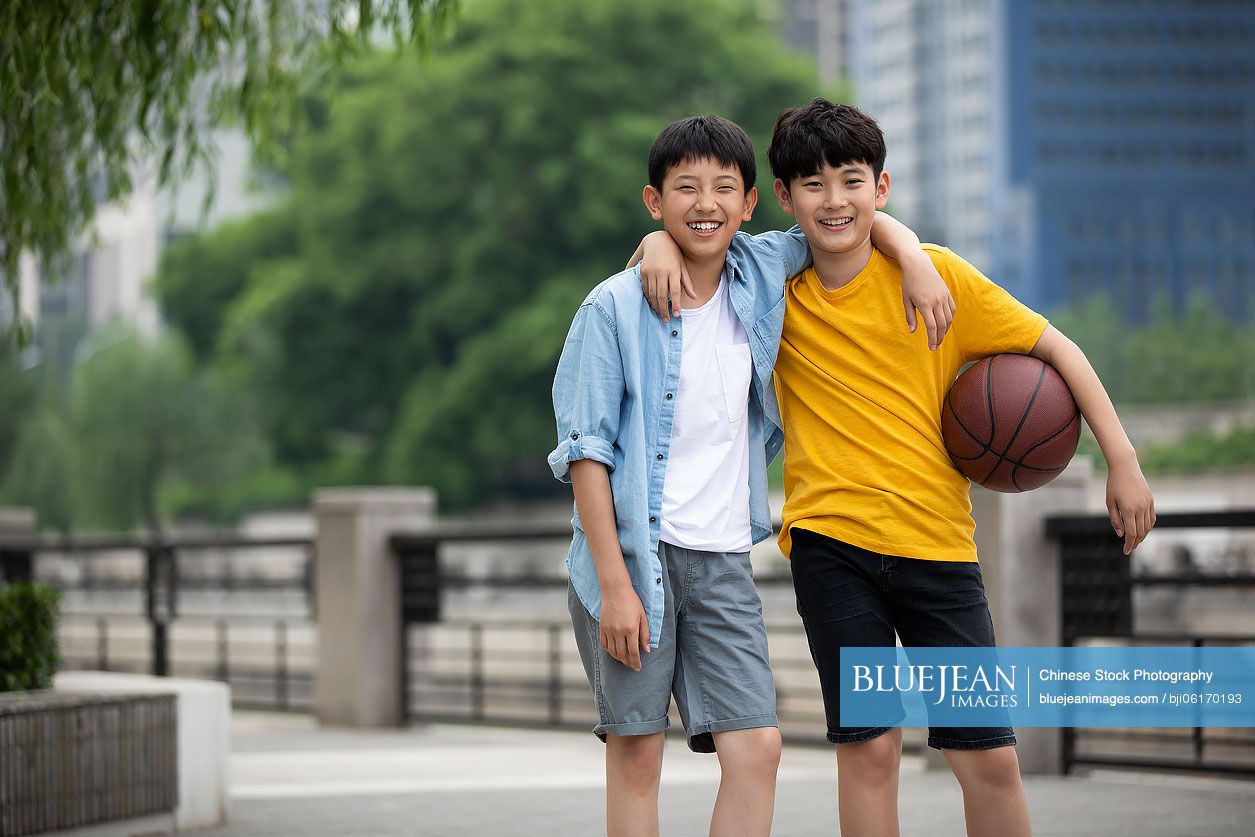 Chinese boys playing basketball outdoors