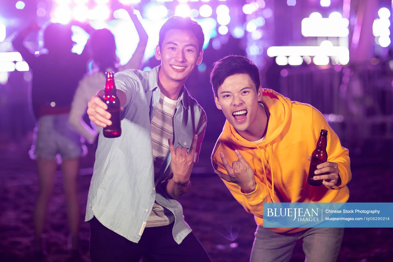 Happy young Chinese friends at music festival