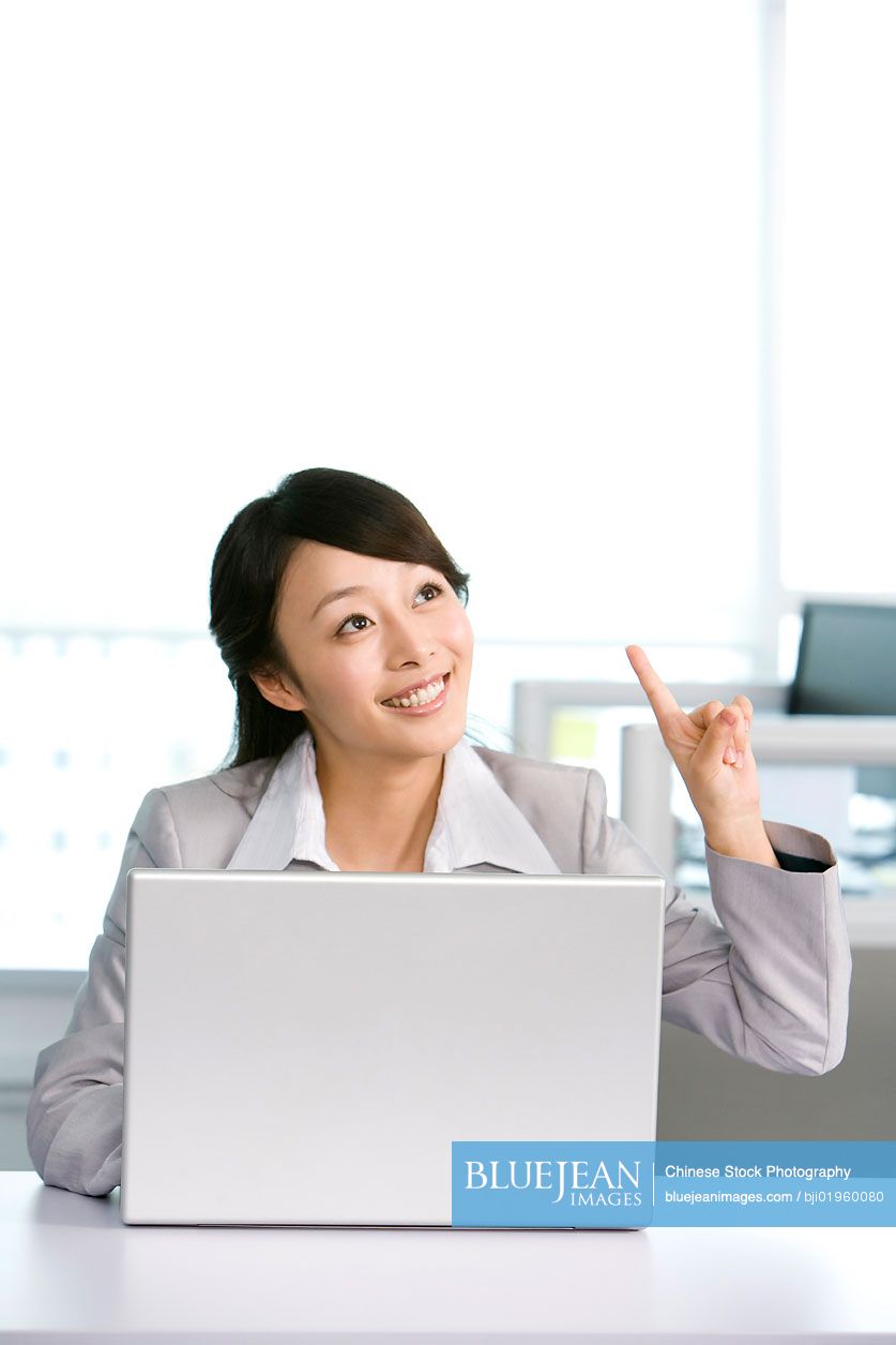 Chinese office worker at her desk