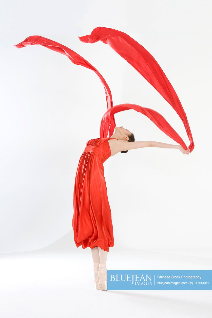 Young Chinese woman in a red dress dancing-High-res stock photo for ...