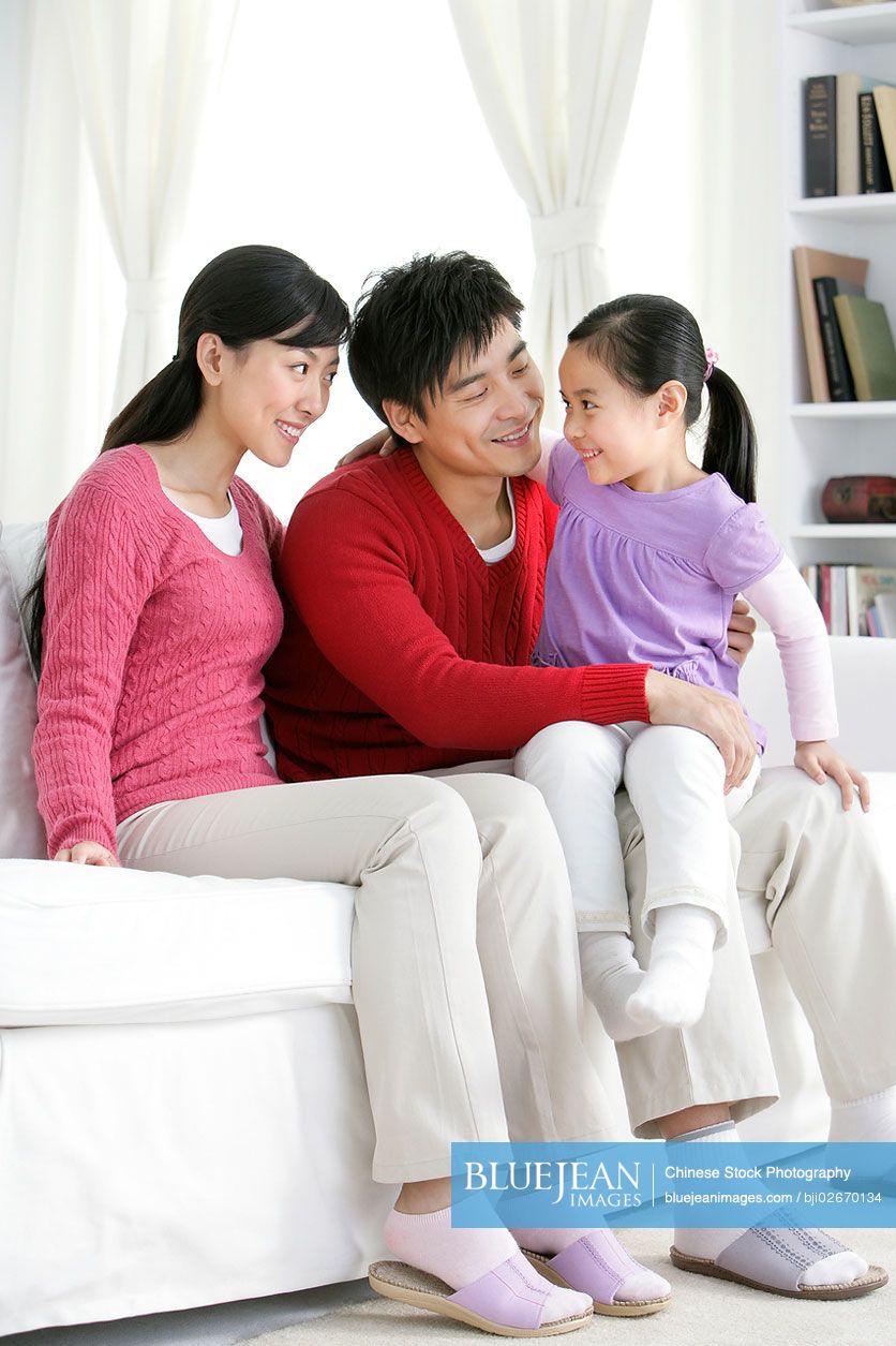 Young Chinese family in living room