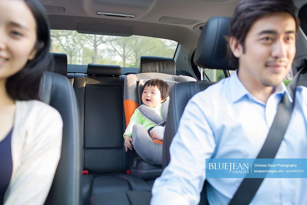 Cute Chinese baby sitting in car back seat