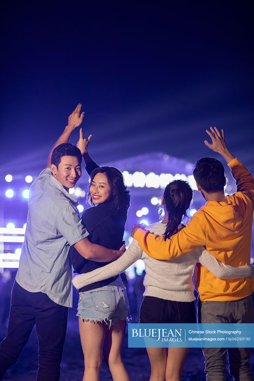 Happy young Chinese friends at music festival