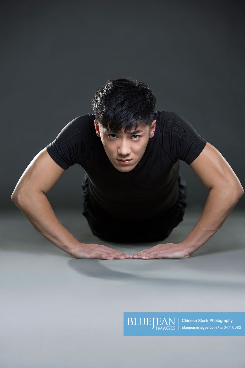Young Chinese man doing push-ups